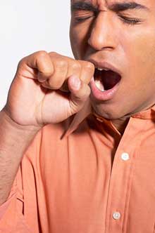 Man yawning due to the physical effects of sleep deprivation.