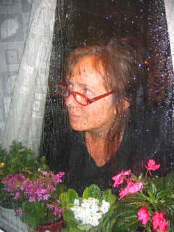 Woman with seasonal depression looking out the window.